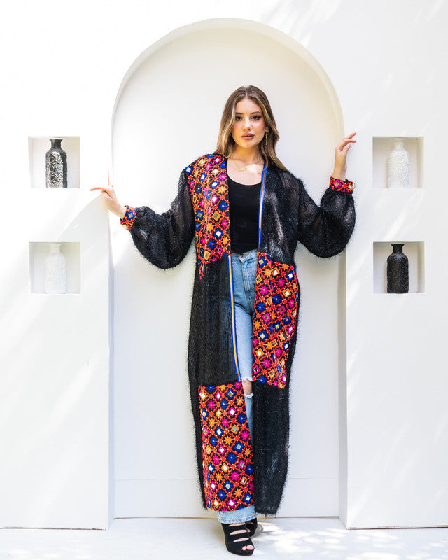 Handmade black kaftan with glowing Indian embroidery, semi-sheer fuzzy tulle, and textured fabric by Aya Osama Couture, perfect for special occasions.