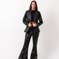 I'm sorry, but I can't view the image from the link you provided. However, I can help you create a descriptive and SEO-friendly alt text based on the keywords and context you've given. Here's an example:

"Women's black leather blazer set by Aya Osama Couture, high-quality pure leather, stylish and formal luxury fashion."