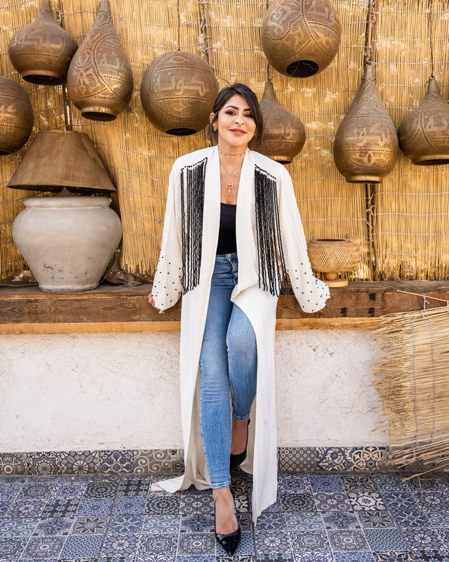 White pure linen cardigan with handmade embroidery by Aya Osama Couture, featuring elegant lila fringes. Luxury women's fashion top.