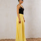 Yellow flowy pants by Aya Osama Couture, made from lightweight CY fabric, perfect for summer; stylish, comfortable, and trendy Egyptian fashion.