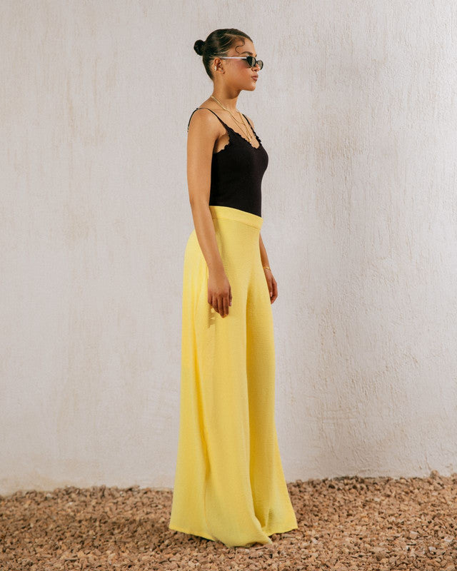 Yellow flowy pants by Aya Osama Couture, made from lightweight CY fabric, perfect for summer; stylish, comfortable, and trendy Egyptian fashion.